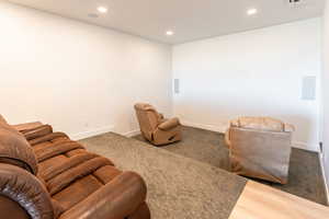 Sitting room with recessed lighting and dark wood-style flooring