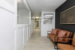 Hall with light wood-style flooring