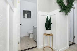Half bathroom featuring light wood-type flooring and vanity