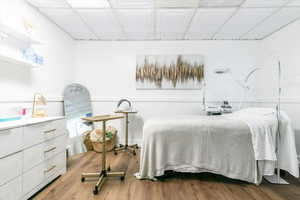 Bedroom featuring wood finished floors and an ornate ceiling