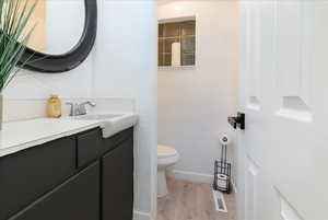 Half bath featuring vanity and light wood finished floors