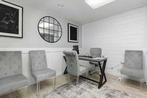 Office featuring wood finished floors and wood walls