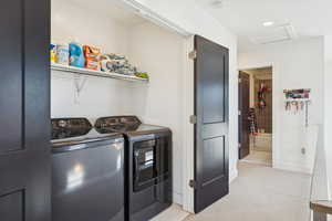 Laundry room featuring washing machine and dryer, light carpet, recessed lighting, and attic access