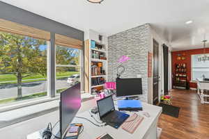 Office featuring dark wood-style flooring and a chandelier