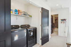 Washroom featuring separate washer and dryer, light colored carpet, recessed lighting, and attic access