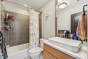 Full bathroom featuring vanity and shower / tub combo with curtain