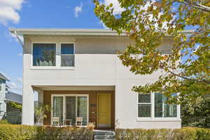View of front facade with stucco siding and a porch