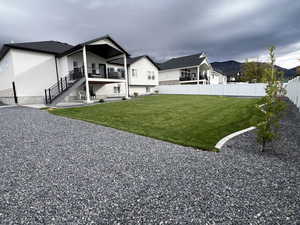 Rear view of property featuring a patio area, a fenced backyard, stucco siding, and stairs