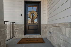 View of exterior entry with stone siding