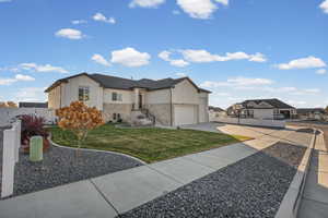 View of side of property featuring board and batten siding, driveway, stone siding, and a residential view