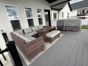 Deck featuring outdoor lounge area and a grill