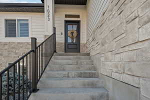 Property entrance featuring stone siding