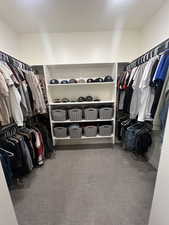 Walk in closet featuring light colored carpet