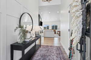 Entryway with recessed lighting, light wood-style floors, and a chandelier