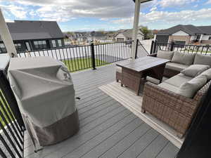 Deck with a residential view, outdoor lounge area, and a grill