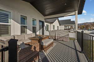 Wooden terrace featuring a mountain view and an outdoor hangout area