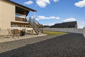 Fenced backyard featuring a patio area and stairs