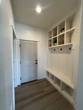 Mudroom with dark wood-style floors and baseboards