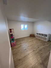 Bonus room featuring light wood-type flooring and baseboards