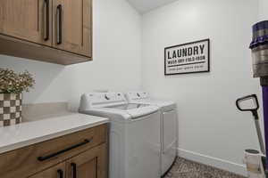 Laundry room featuring washing machine and clothes dryer and cabinet space