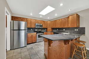 Gorgeous granite countertops and stainless appliances. Skylight  provides lots of light.