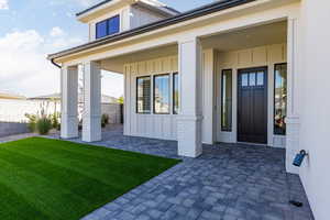 Doorway to property featuring board and batten siding and a porch