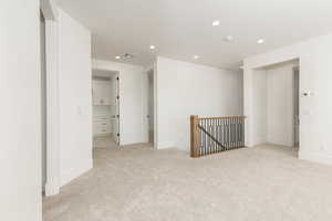 Spare room with recessed lighting and light colored carpet