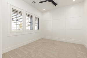 Unfurnished room with light carpet, recessed lighting, a decorative wall, and a ceiling fan