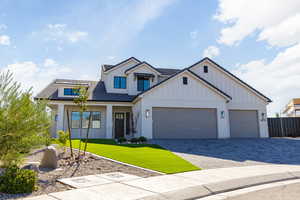 Modern farmhouse featuring board and batten siding, brick siding, decorative driveway, a porch, and an attached garage