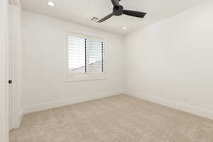 Empty room featuring light carpet, recessed lighting, and ceiling fan