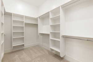 Walk in closet with light carpet