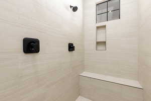 Full bathroom with a tile shower