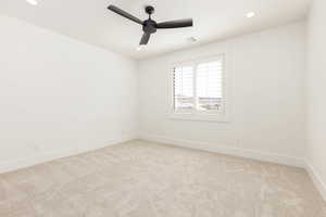Empty room featuring light carpet, recessed lighting, and ceiling fan