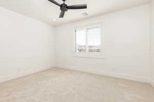 Unfurnished room featuring light carpet, a ceiling fan, and recessed lighting