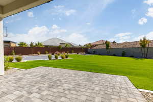 Fenced backyard featuring a patio area