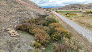 Aerial overview of property's location featuring property parcel outlined and a mountainous background