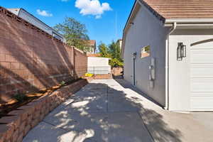 View of property exterior featuring stucco siding and a gate