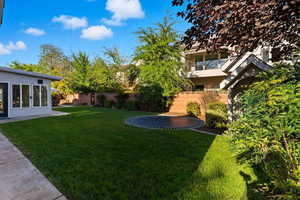 Fenced backyard featuring french doors and a patio
