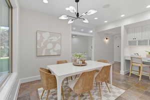 Dining space with recessed lighting, stone tile floors, built in study area, and a chandelier