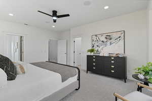 Bedroom with light carpet, a ceiling fan, and recessed lighting