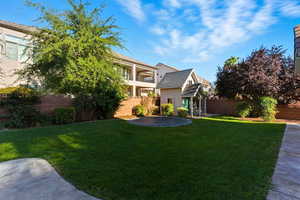 Fenced backyard featuring a balcony, a trampoline, and a patio area