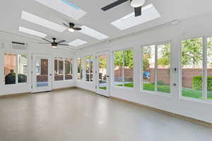 Unfurnished sunroom with baseboards and a skylight