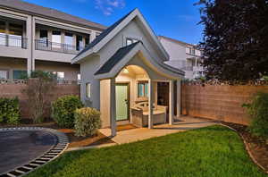 Back of property featuring stucco siding and a trampoline