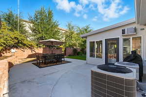 Fenced backyard featuring a patio area and outdoor dining area