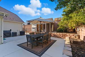 Fenced backyard featuring outdoor dining space and a patio