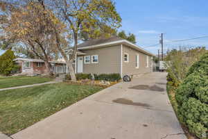 View of front of property featuring a front lawn and roof with shingles