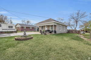 View of front of house with a patio area and a shingled roof