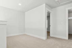 Additional living space featuring light carpet, attic access, recessed lighting, and a textured ceiling