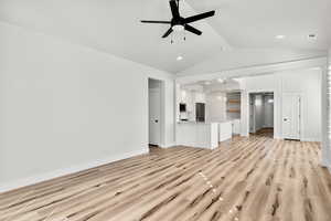 living room featuring light wood-style floors, lofted ceiling, and ceiling fan