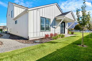 View of side of property featuring board and batten siding and roof with shingles